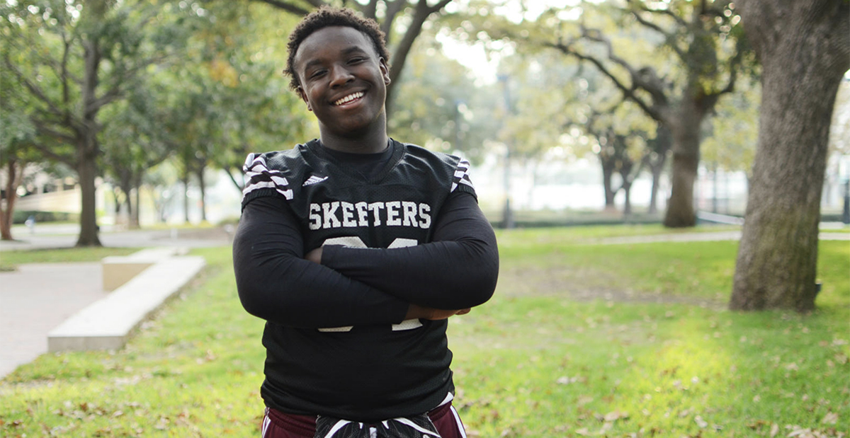 high school boy with black football jersey on